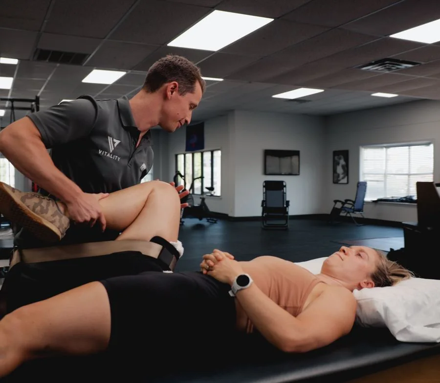 A patient doing a hip and lower-body strength exercise at Vitality Therapy and Performance