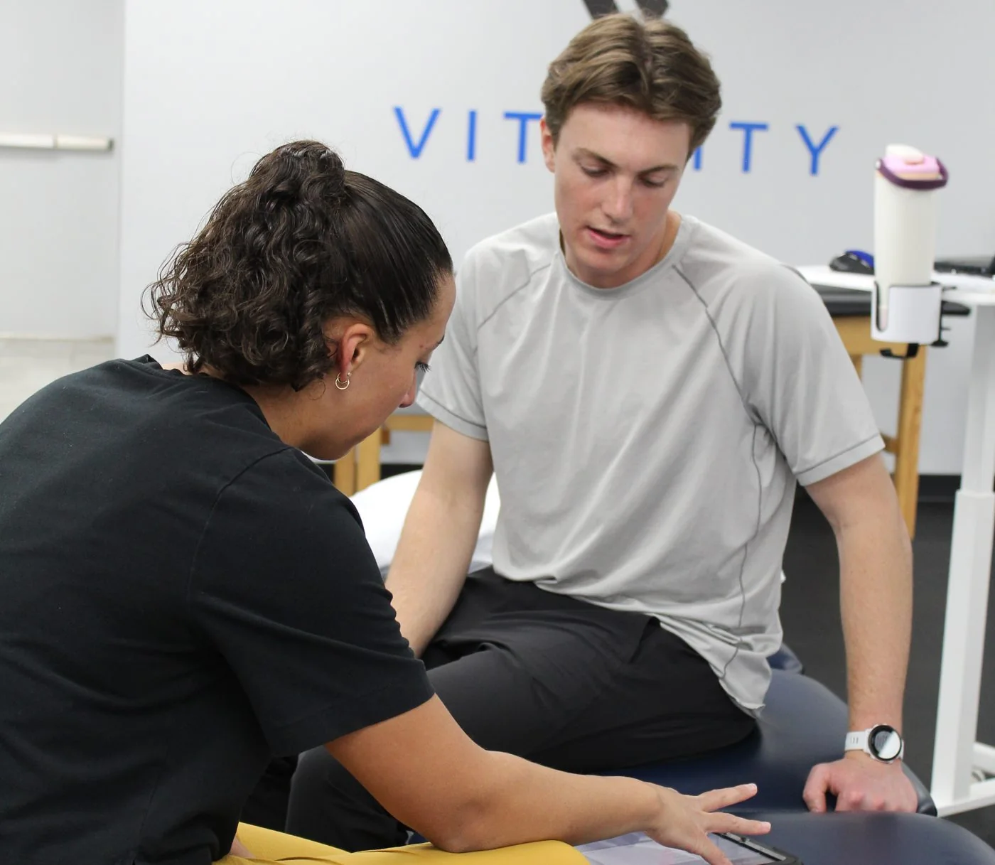 Vitality therapist reviewing a patient's plan