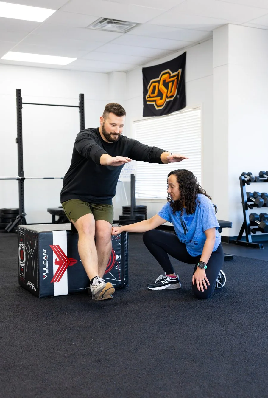 A patient doing a deadlift or hip-hinge exercise at Vitality Therapy and Performance